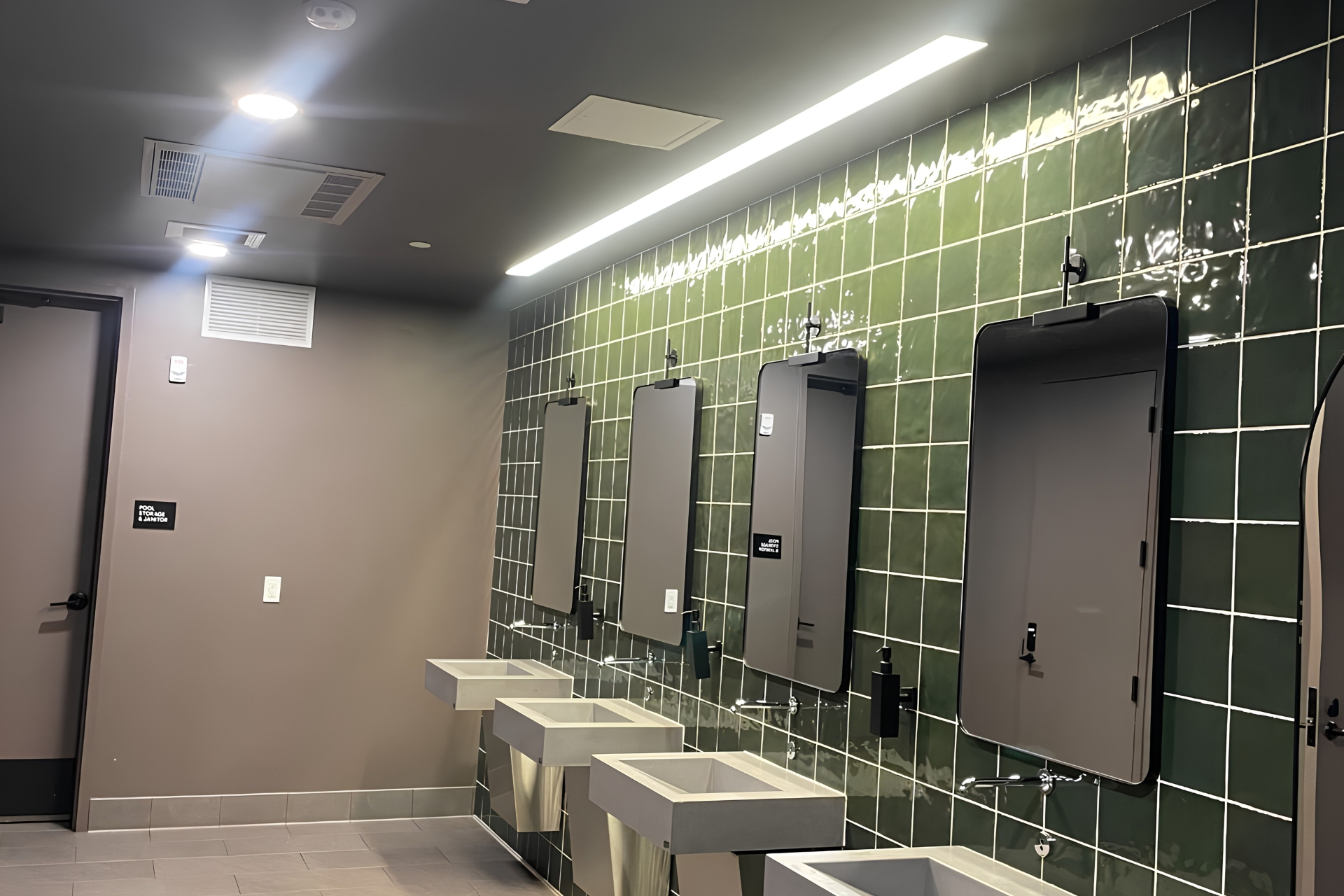 Commercial interior with lighting, mirrors, and wall-mounted fixtures.